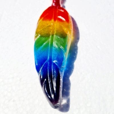 Rainbow ashes keepsake feather on a whitebackground