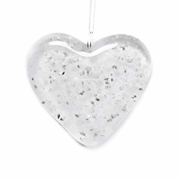 A clear heart with silver glitter and ashes fused inside