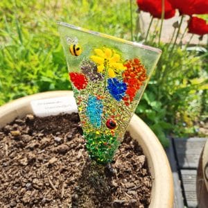 A Glass Flower Meadow Plant Stake in a flower pot