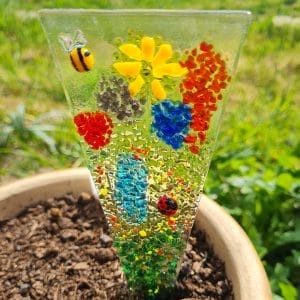 A Glass Flower Meadow Plant Stake in a flower pot