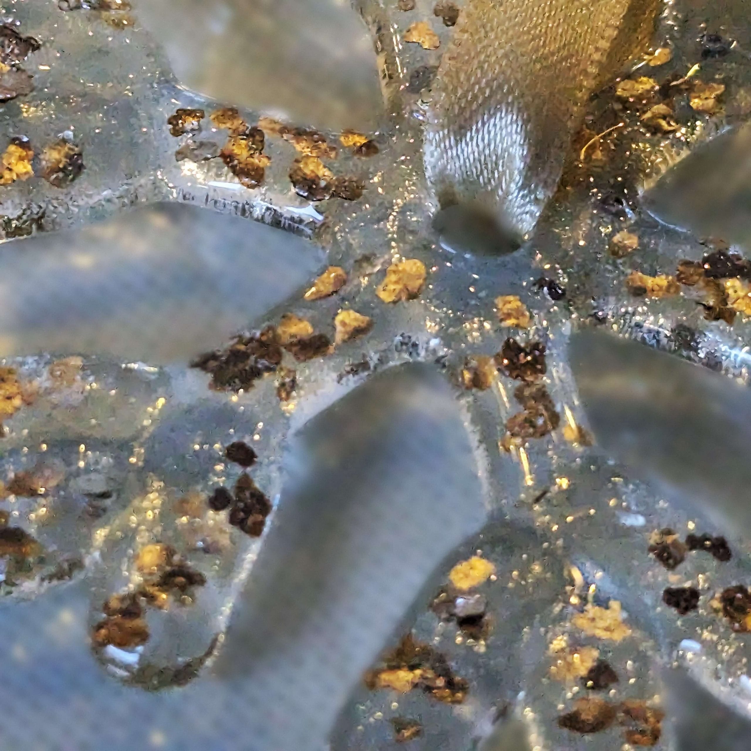 A handmade fused glass gold flecked snowflake closeup photo