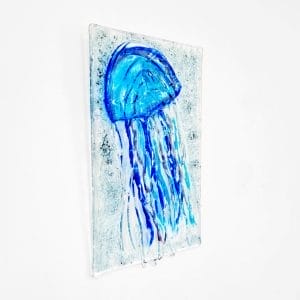 Blue Jellyfish made of glass, hanging on the wall.