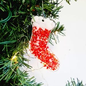 Fused Glass Christmas Stockings in red and white and red and gold on a green Christmas tree