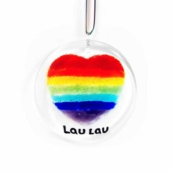 A round circle suncatcher featuring a heart made with rainbow colours in vertical stripes.