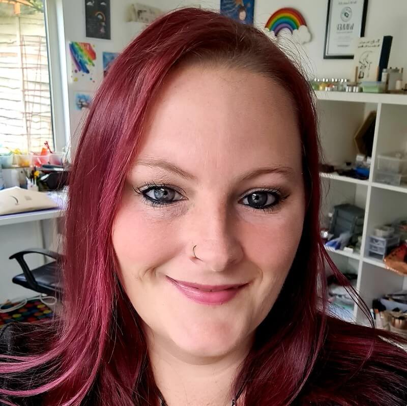 A photo of Kelly Biggs smiling at the camera - Fused Glass Artist