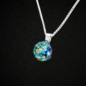A blue dichroic glss necklace on a black background