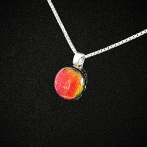 Red dichroic necklace on a black background