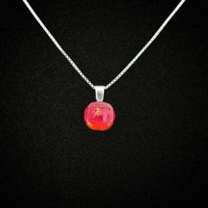 Dichroic Glass Red Pendant with ashes on a 925 Sterling Silver Necklace on a black background